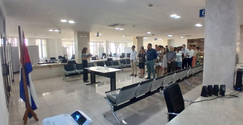 Trabajadores de la OZED Mariel acompañan a tres de los cuadros de reciente aprobación a la firma del Código de Ética. 